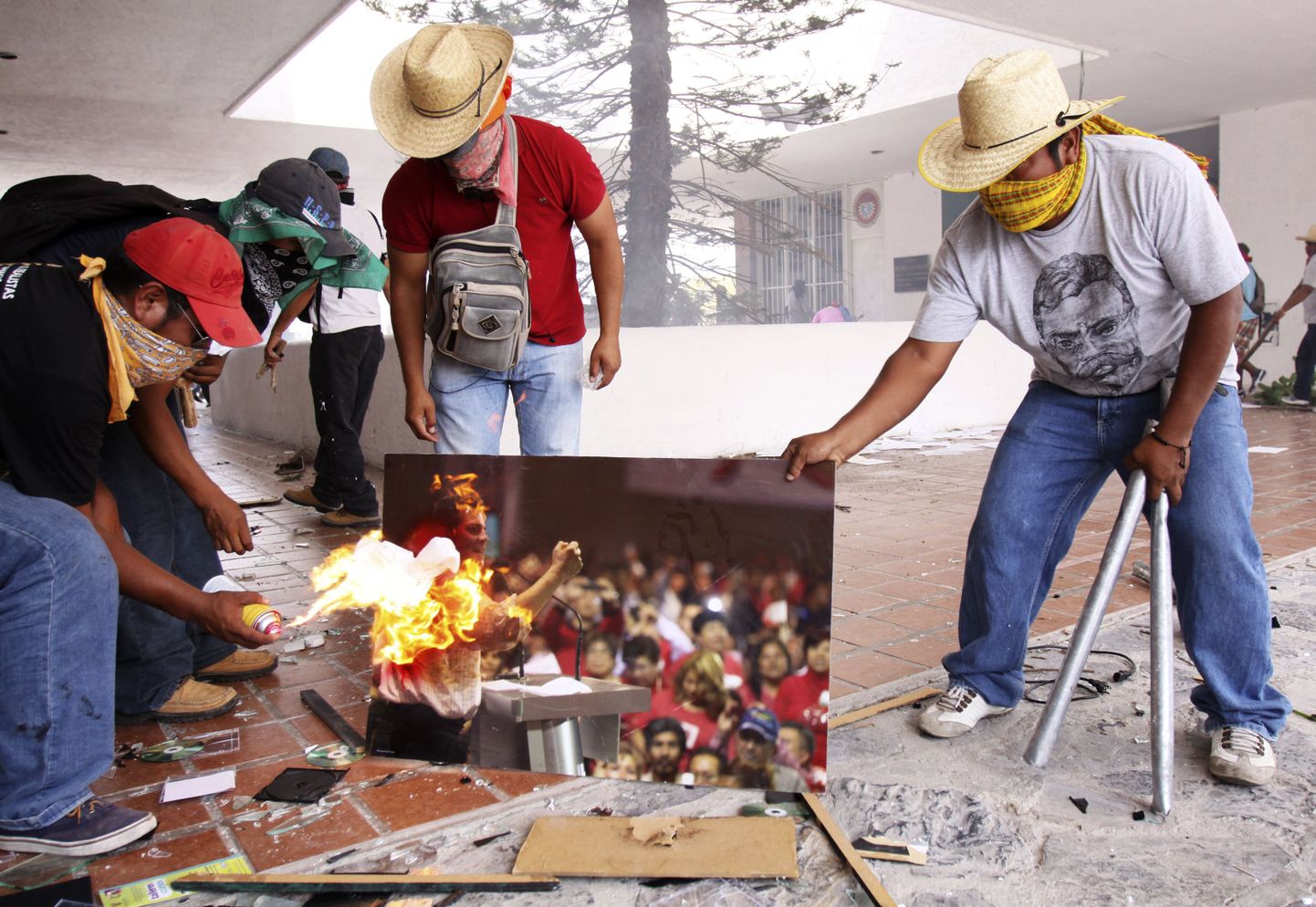 Chilpancingo õpetajad põletavad Revolutsioonilise partei (PRI) kontorit rünnates Mehhiko presidendi Enrique Peña Nieto plakatit.