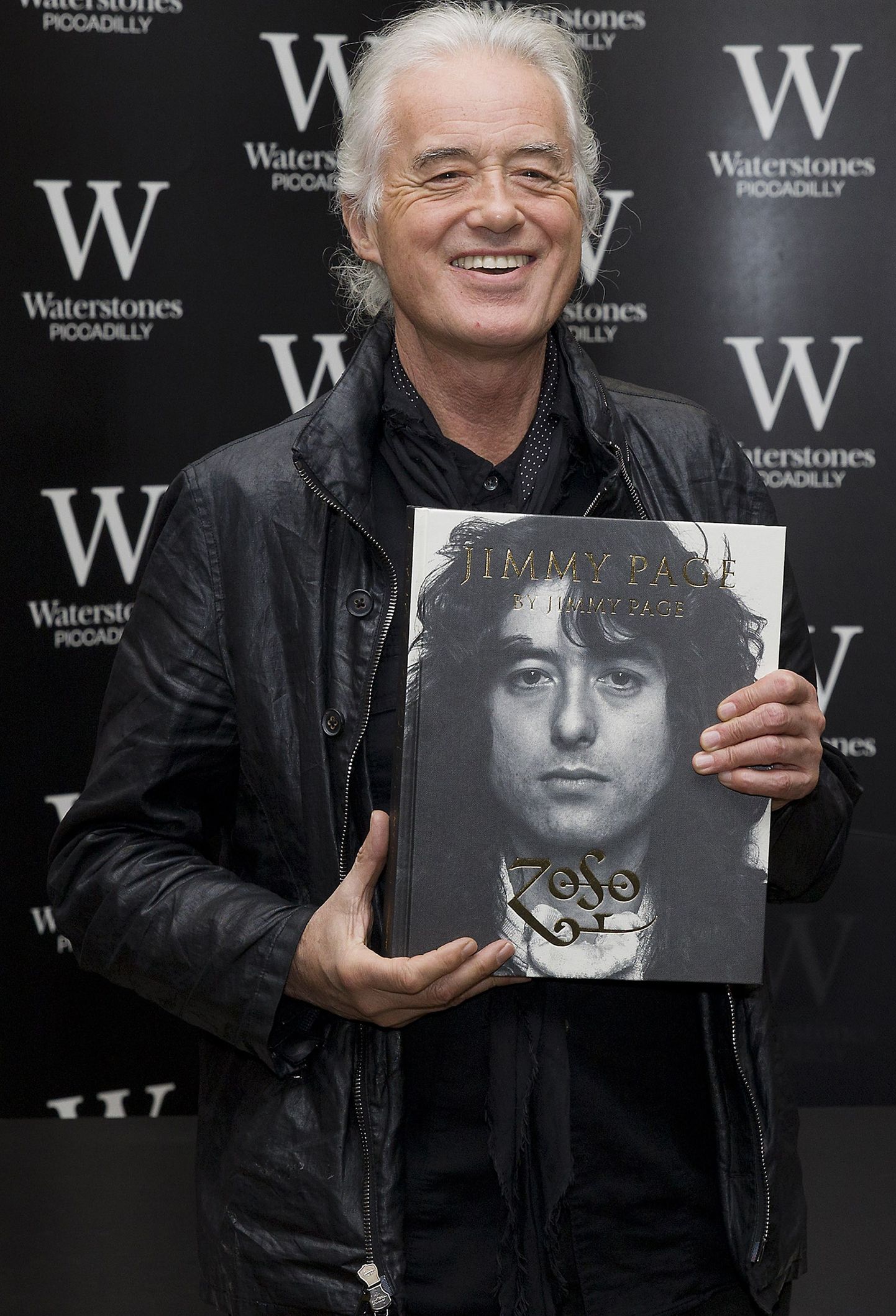 British musician Jimmy Page poses for pictures before signing his new book entitled 'Jimmy Page by Jimmy Page' at a Waterstones book shop in central London, on December 2, 2014. AFP PHOTO / JUSTIN TALLIS