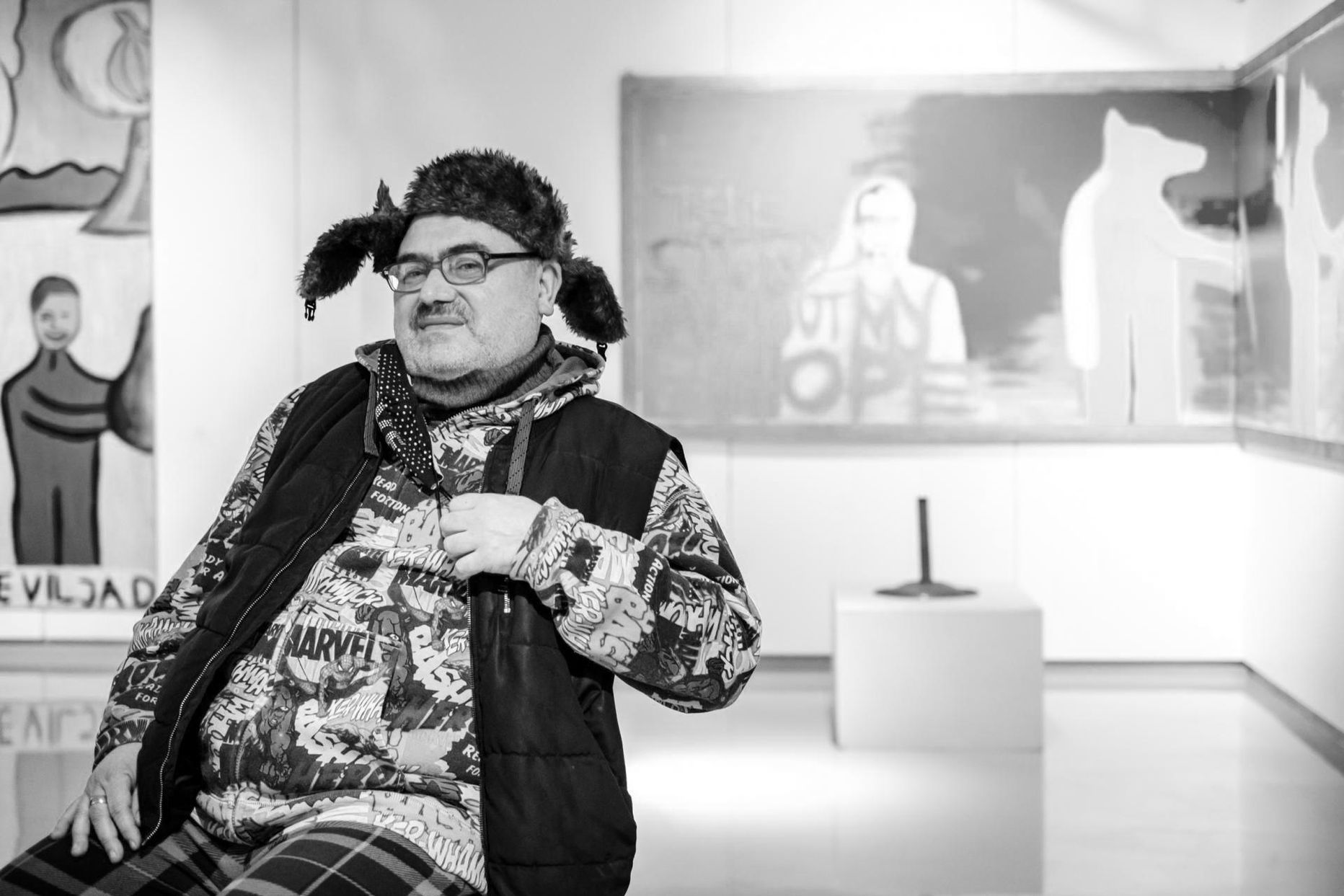 Andrus Joonas oma veebruarikuisel retrospektiivsel juubelinäitusel “Meelesurfar” Pärnu muuseumis, tagant maalil paistmas Kollane Huntmees.
