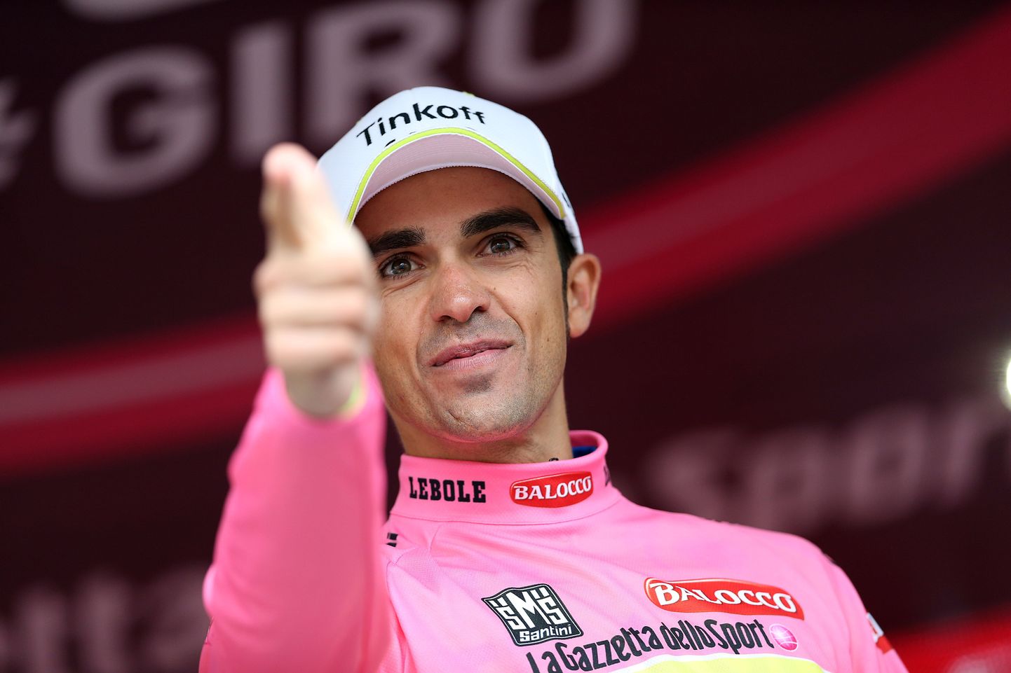 Spanish Alberto Contador (Tinkoff Saxo) celebrates the pink jersey of overall leader on the podium of the 14th stage of the 98th Giro d'Italia, Tour of Italy, a 60km Individual Time Trial between Treviso and Valdobbiadene on May 23, 2015 in Valdobbiadene. Spaniard Alberto Contador bounced back from a crash on Friday to retake the overall lead in the Giro d'Italia after Saturday's 14th stage. The 32-year-old, who won the Italian race in 2008, finished third on the day but picked up three minutes on overnight leader Fabio Aru during the 59.4km time-trial which was won by Sky's Belarus rider Vasil Kiryienka.  AFP PHOTO / LUK BENIES