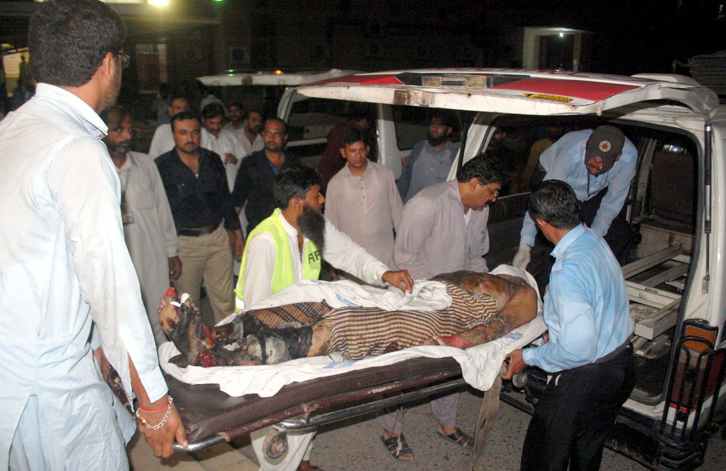ATTENTION EDITORS - VISUAL COVERAGE OF SCENES OF INJURY OR DEATH    Police officers and rescue workers move the body of a victim who was killed in an explosion to a hospital in Multan, Pakistan, September, 13, 2015. Seven people were killed and 43 wounded when an explosion occurred after a motorbike hit a rickshaw. It appeared that the motorbike had been rigged with explosives, police said. REUTERS/K. Chaudhry     TEMPLATE OUT