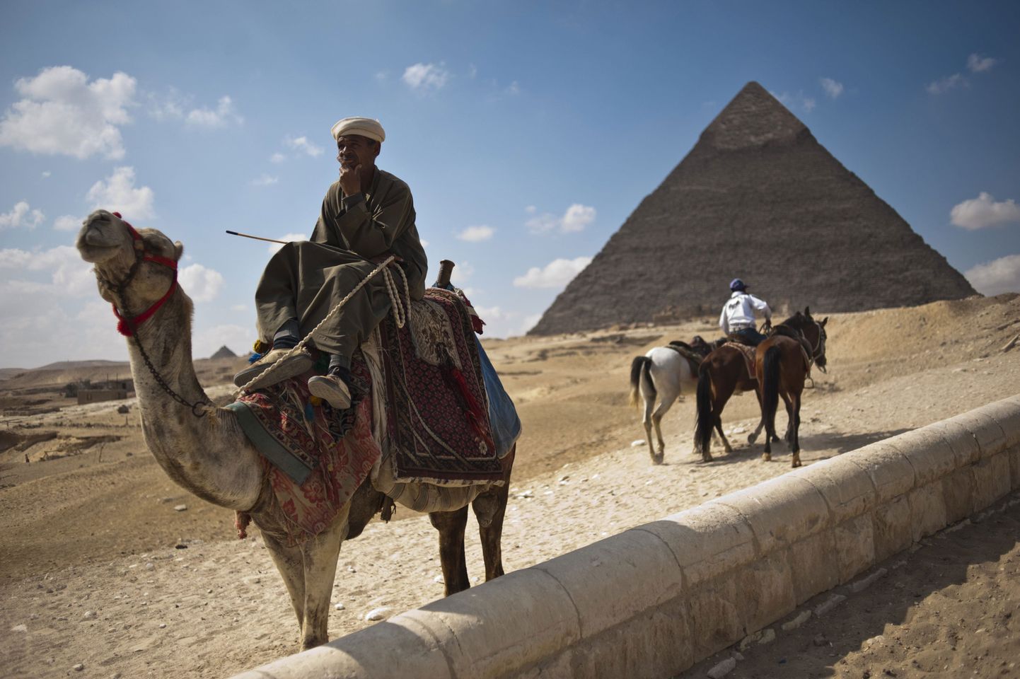 Egiptuse mees ootab Giza püramiidide juures turiste.