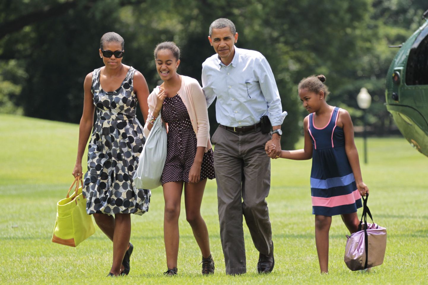 President Barack Obama abikaasa Michelle'i ja tütarde Malia (vasakult teine) ja Sashaga Valge Maja murul.