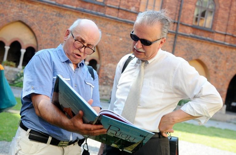 Янис Крастиньш (слева) рассматривает книгу о Риге, написанную журналистами