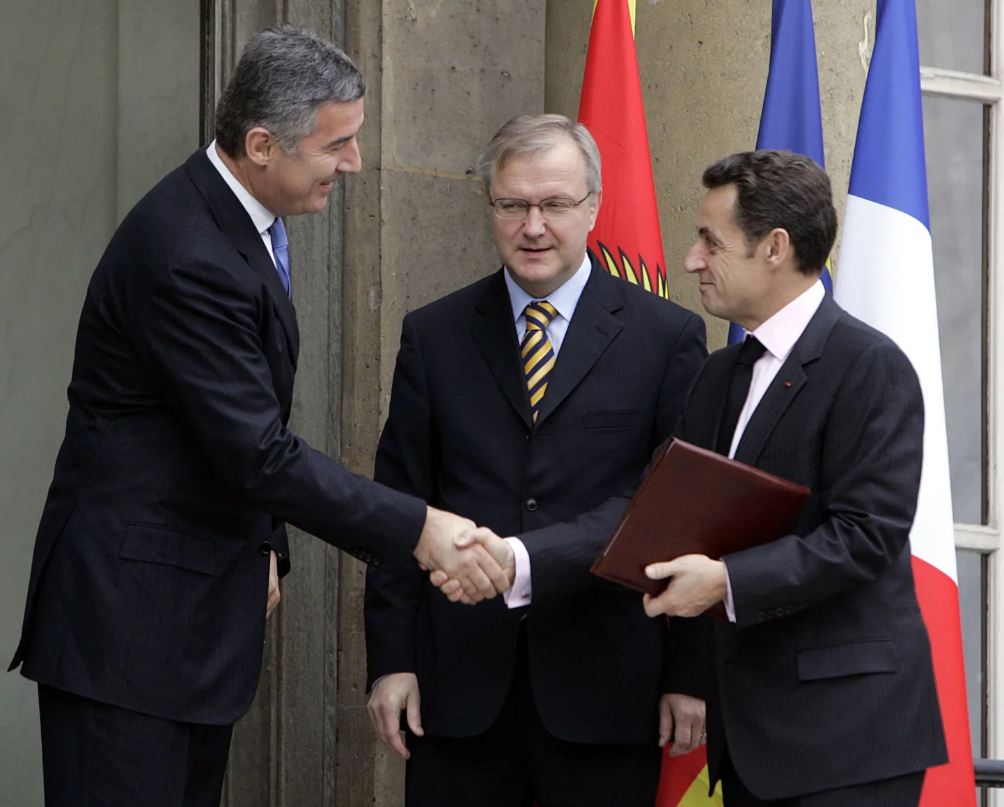 Prantsusmaa president Nicolas Sarkozy (paremal) surumas kätt Montenegro peaministri Milo Djukanoviciga (vasakul). Keskel Euroopa Liidu laienemisvolinik Olli Rehn.