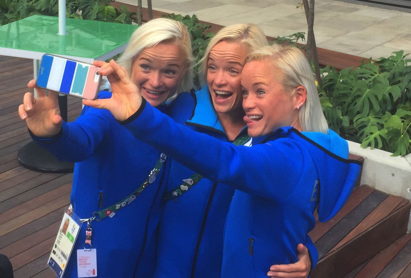 In this Friday, Aug. 12, 2016 photo, Estonian triplets, from left, Leila, Liina and Lily Luik take a selfie outside the Main Press Center at the 2016 Summer Olympics in Rio de Janeiro, Brazil. Olympic spectators face the challenge Sunday, Aug. 14 of trying to tell the blonde sisters apart from afar in the marathon at the Rio de Janeiro Games. (AP Photo/Rob Harris)