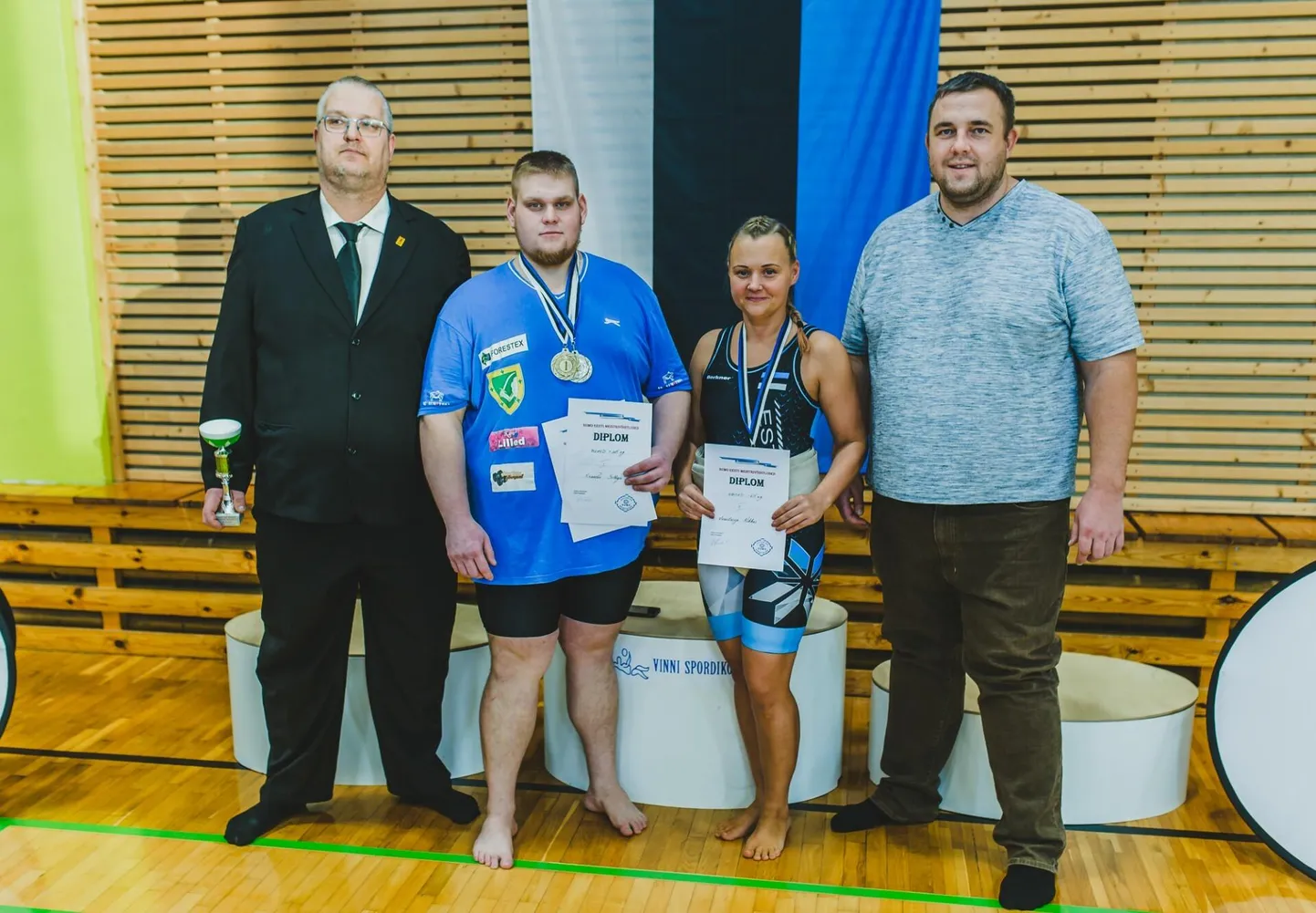 Valgalased Anastasija Kikkas ja Xsander Solbaja koos sumo­treeneri Meelis Höövelsoni (vasakul) ja Eesti Sumoliidu presidendi Kaido Höövelsoniga