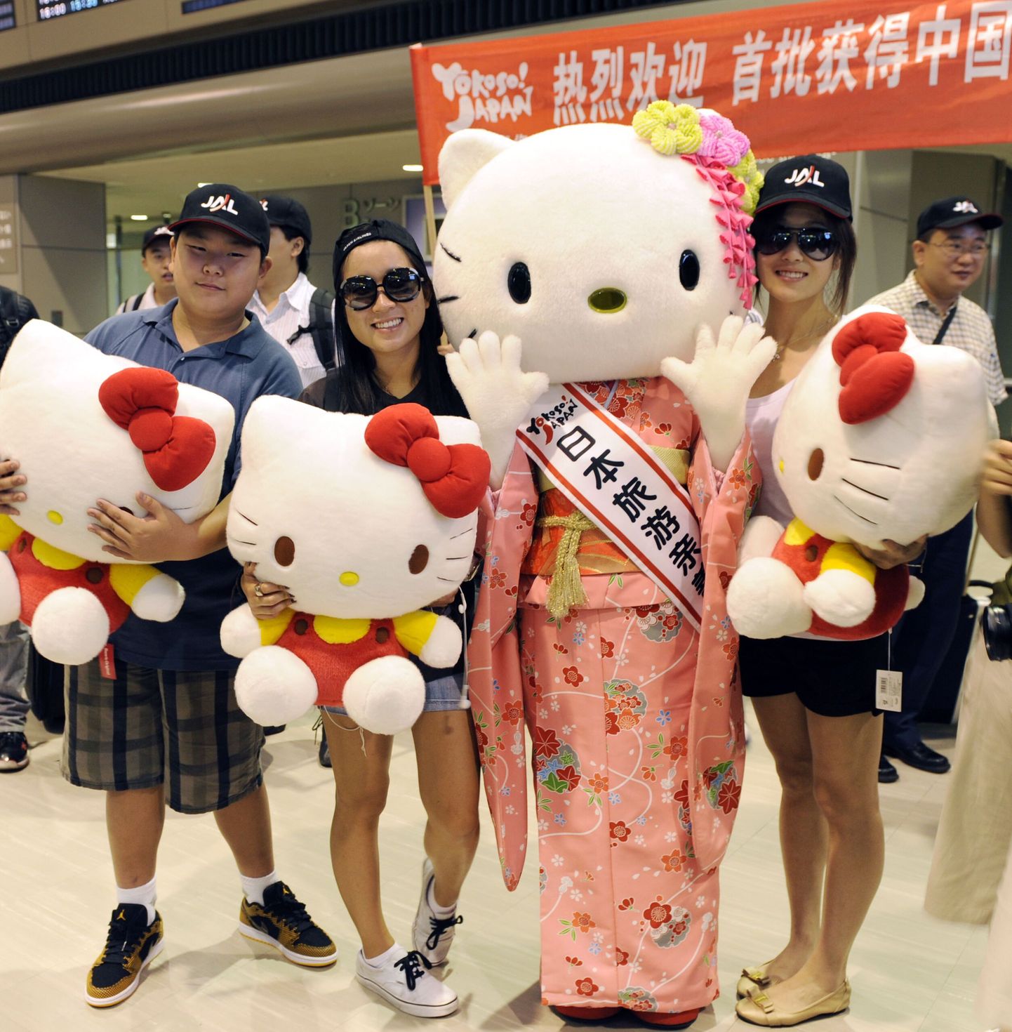 Hiinlased poseerimas Jaapani turismisaadiku Hello Kittyga Narita lennujaamas