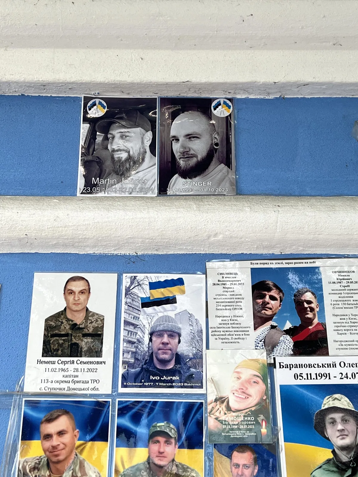 A photo of Martin Jääger (top left) alongside the photos of two other Estonian volunteers who died in the Ukrainian war, displayed on a memorial wall in Kyiv.
