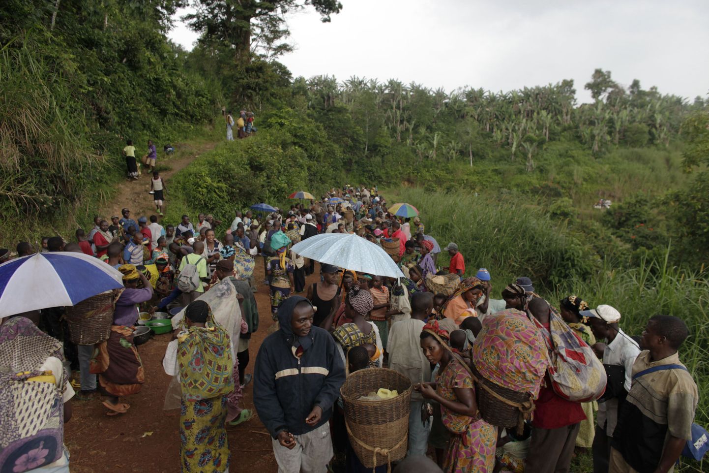 ÜRO rahuvalvajad saadavad massivägistamise ohvriks langenud küla elanikke Kibuast tagasi Livungisse.