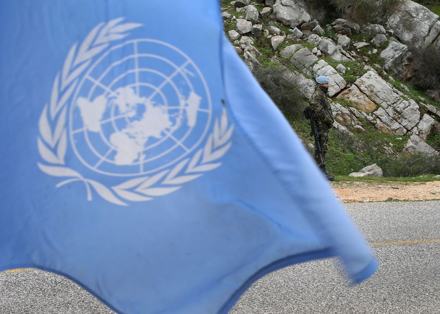 A United Nations flag waves as Spanish U.N. peacekeepers carry out a foot patrol in the disputed Chebaa Farms area between Lebanon and Israel, in southeast Lebanon, Tuesday Feb. 24, 2015. A Spanish peacekeeper was killed in south Lebanon last month during a flare-up in hostilities between Israel and Hezbollah. The U.N. peacekeeping force known as UNIFIL has been deployed in south Lebanon since 1978 and monitors the border between Lebanon and Israel. (AP Photo/Hussein Malla)