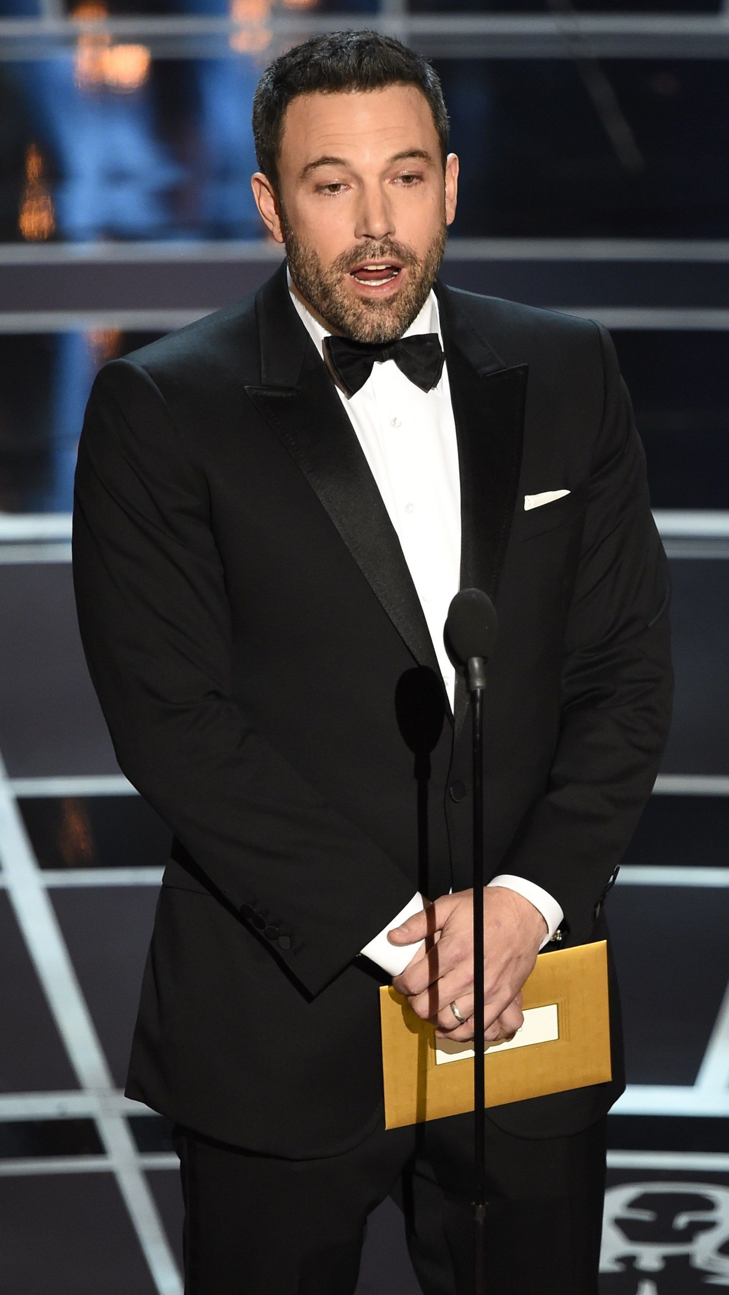Ben Affleck presents an award on stage at the 87th Oscars February 22, 2015 in Hollywood, California. AFP PHOTO / Robyn BECK