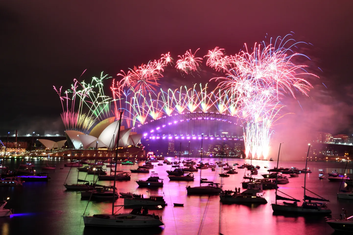 Fireworks explode over the Sydney Opera House and Sydney Harbour Bridge during downsized New Year's Eve celebrations due during the COVID-19 pandemic, in Australia, January 1, 2021. AAP Image for NSW Government/Mick Tsikas/Handout via REUTERS NO RESALES. NO ARCHIVES. THIS IMAGE HAS BEEN PROVIDED BY A THIRD PARTY