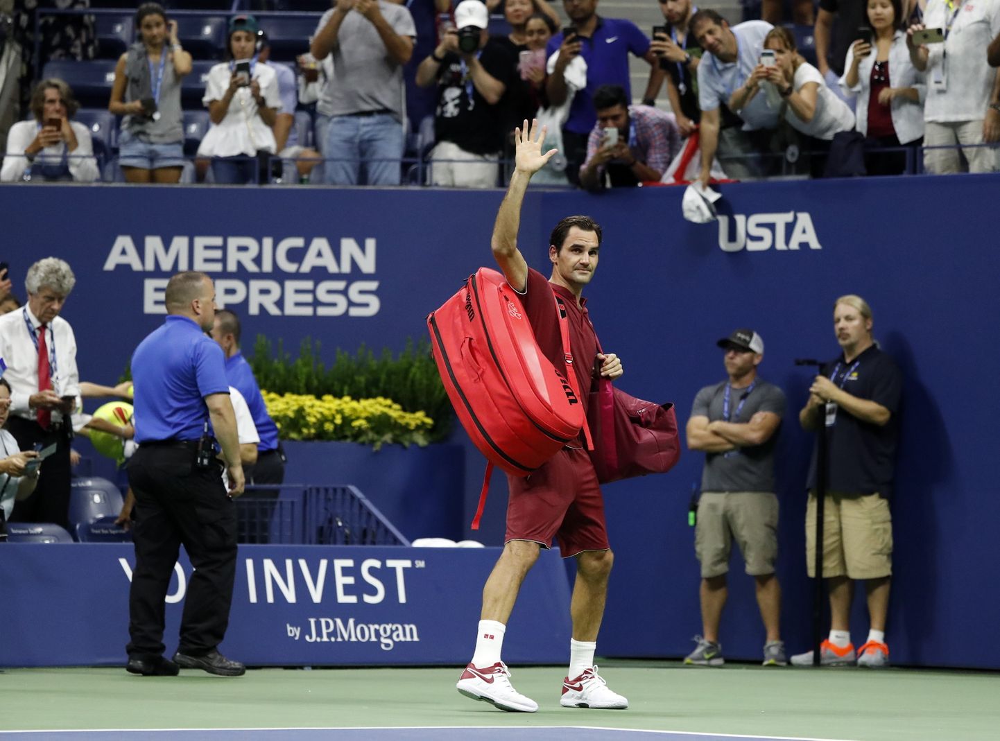 Roger Federer of Switzerland (C) waves to the crowd as he walks off court after losing his match against John Millman of Australia during the eighth day of the US Open Tennis Championships at the Arthur Ashe Stadium in the USTA National Tennis Center in Flushing Meadows, New York, USA, 03 September 2018. The US Open runs from 27 August through 09 September.  EPA/JASON SZENES