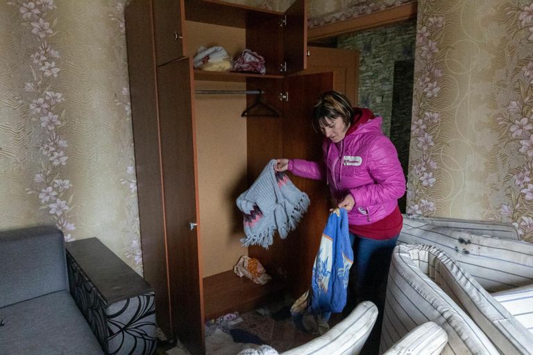 Teacher Natalja shows a stolen wardrobe in her demolished apartment.