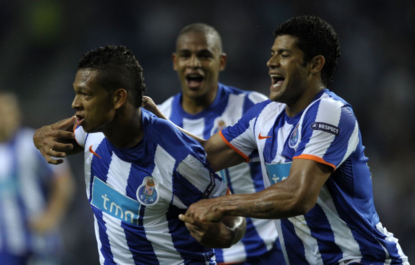 FC Porto's Colombia midfielder Fredy Guarin (L) celebrates with teammates Brazil forward Givanildo de Souza "Hulk" (R) and Brazilian midfielder Fernando Reges (C) after scoring during their UEFA Europa League semifinal first-leg football match against Villarreal at the Dragao Stadium in Porto, on April 28, 2011.    AFP PHOTO/ MIGUEL RIOPA