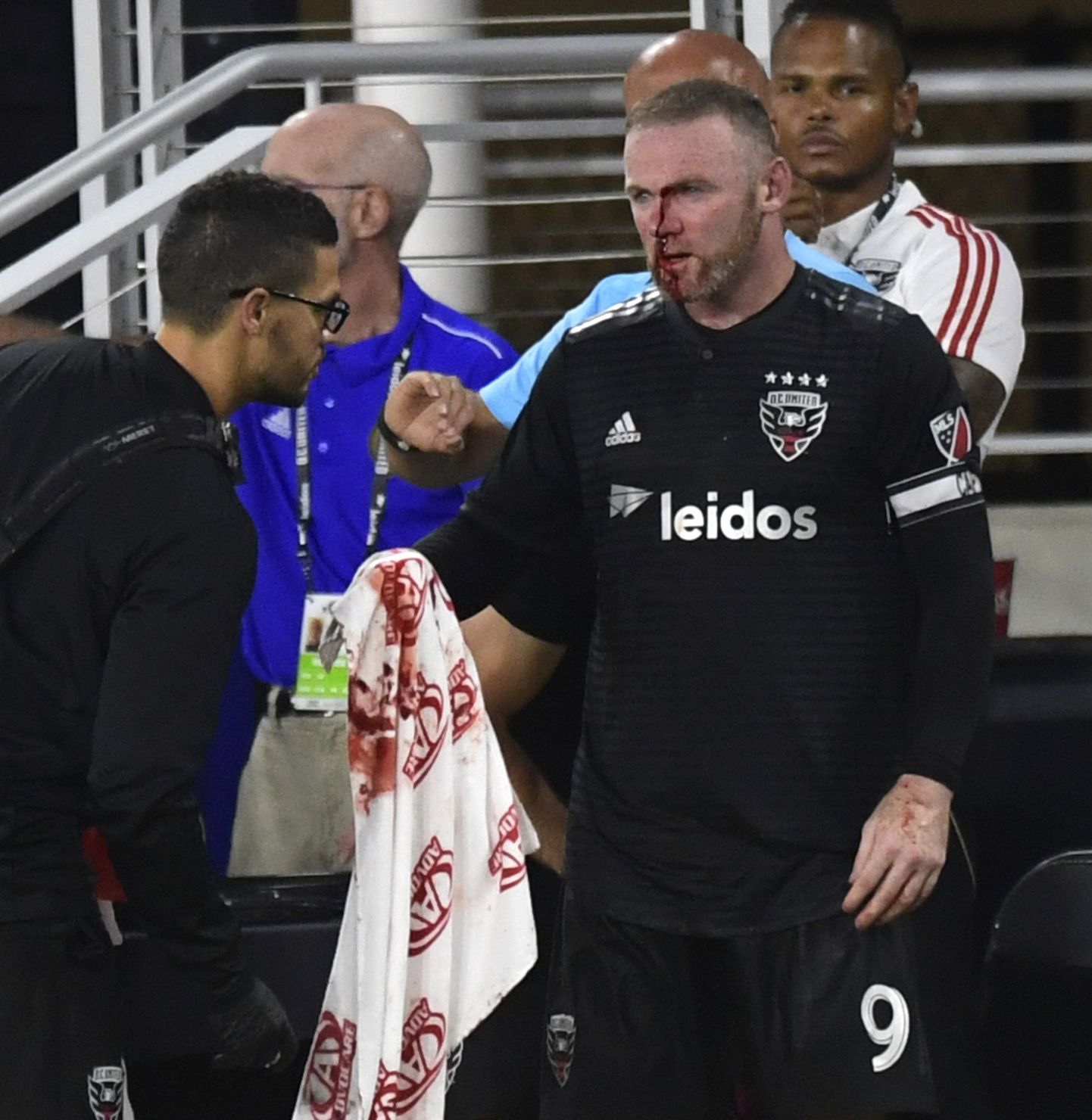 D.C. United forward Wayne Rooney is assisted on the sideline after getting injured during the second half of an MLS soccer match against the Colorado Rapids in Washington, Saturday, July 28, 2018. (AP Photo/Susan Walsh)