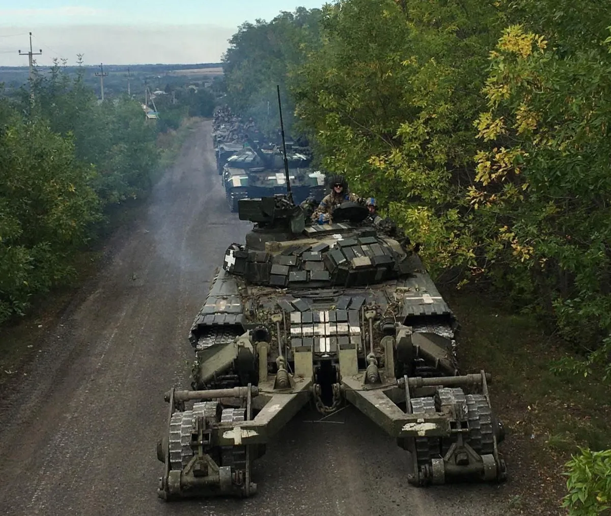 Ukrainian service members ride on tanks during a counteroffensive operation, amid Russia's attack on Ukraine, in Kharkiv region.