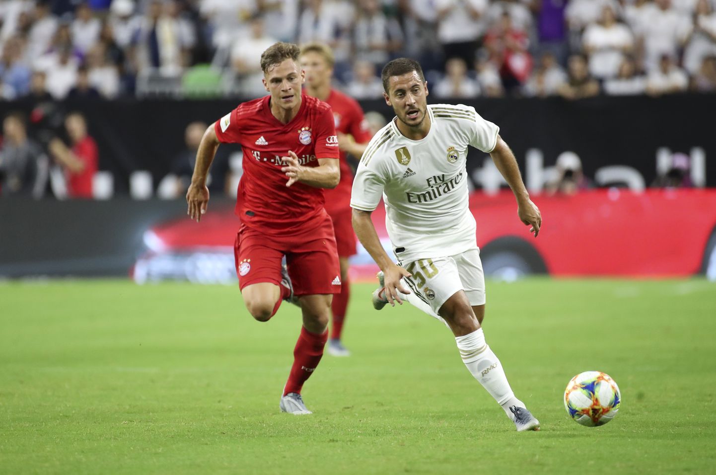 Jul 20, 2019; Houston, TX, USA; Real Madrid forward Eden Hazard (50) controls the ball as Bayern Munich defender Joshua Kimmich (32) chases during the first half of the International Champions Cup soccer series at NRG Stadium. Mandatory Credit: Kevin Jairaj-USA TODAY Sports