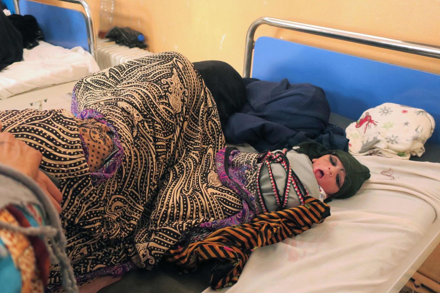 Afgaanlanna puhkab Khosti haiglas sissepakitud vastsündinu kõrval.