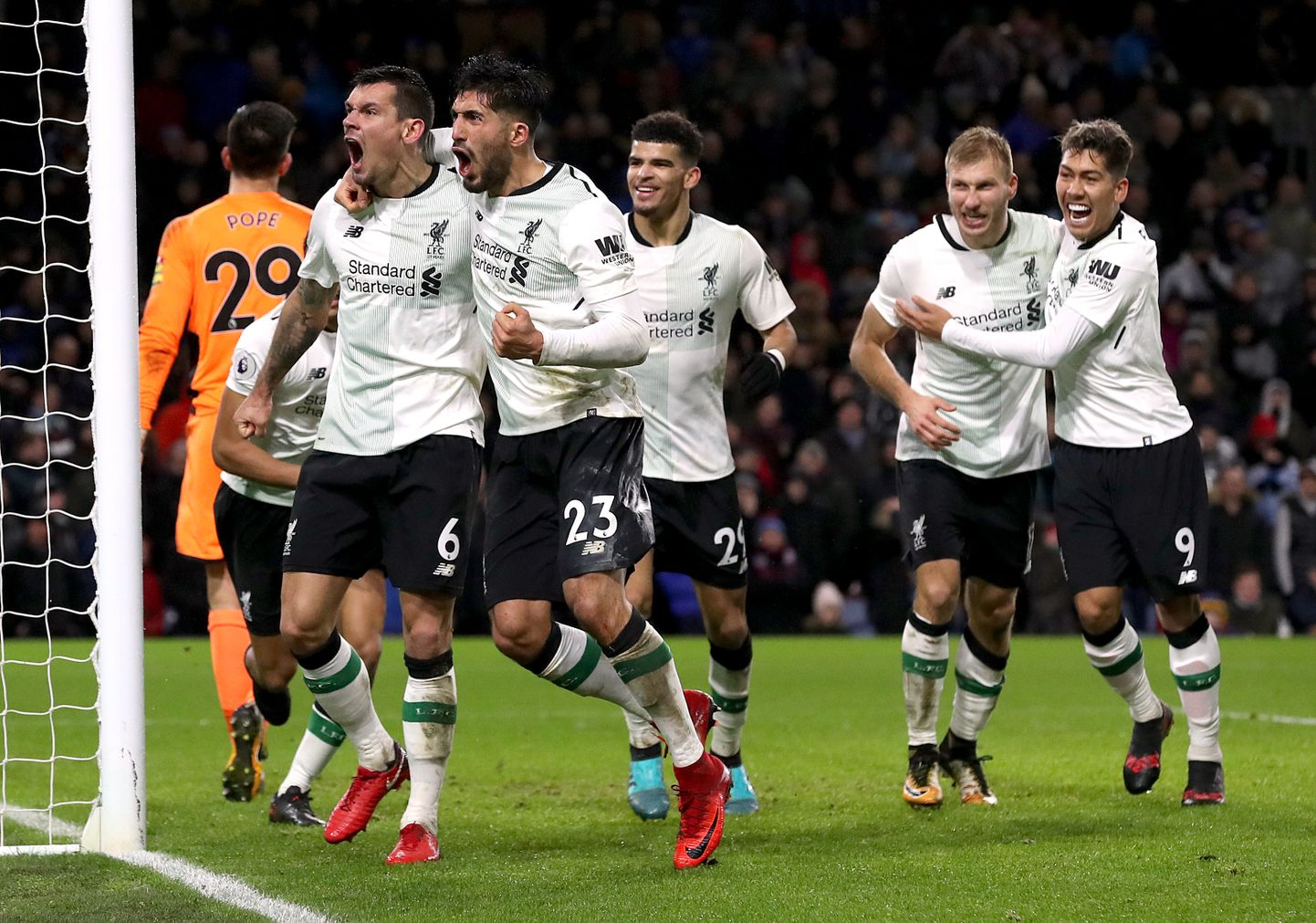 Liverpool's Dejan Lovren (left) and Liverpool's Emre Can (second left) celebrate after Liverpool's Ragnar Klavan (second right) scores his side's second goal of the game during the Premier League match at Turf Moor, Burnley.