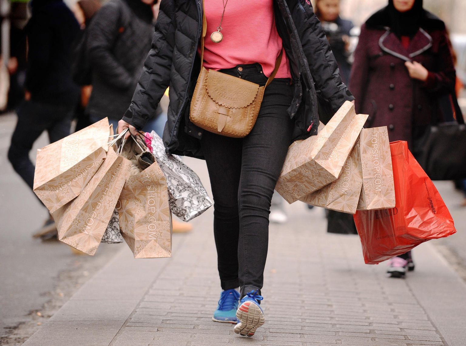 File photo dated 06/12/11 of a person with shopping bags. Retail sales growth flatlined in December - the worst Christmas performance for a decade - according to an index.