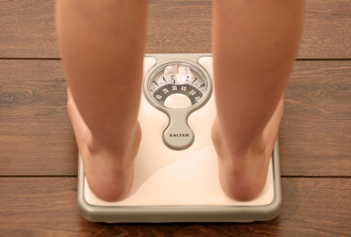 Picture posed by model File photo dated 03/03/14 of an 11 year old girl using a set of weighing scales. Prime Minister Boris Johnson will announce the end of confectionery displays at store checkouts and ban junk food adverts on TV before 9pm as he looks to encourage Britons to shed the pounds.