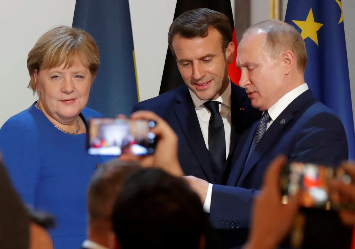German Chancellor Angela Merkel, French President Emmanuel Macron and Russia's President Vladimir Putin attend a joint news conference after a Normandy-format summit in Paris, France December 9, 2019. REUTERS/Charles Platiau