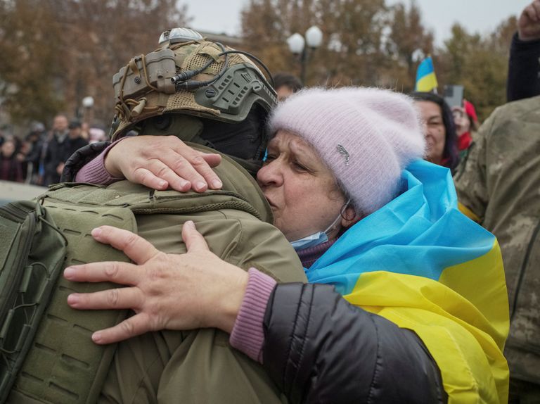 Жительница Херсона обнимает украинского военнослужащего после деоккупации города 12 ноября 2022 года.