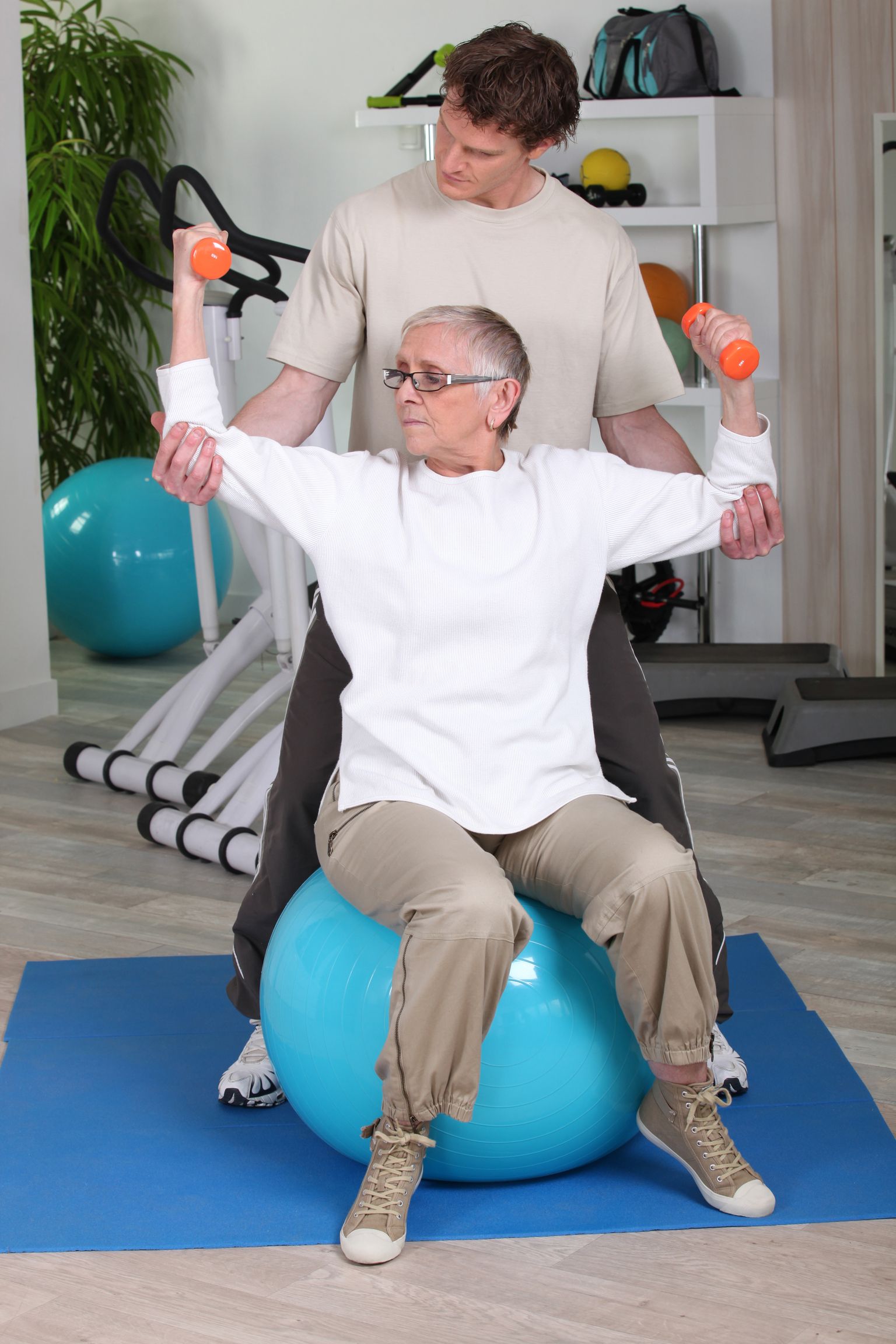 Elderly woman with personal trainer