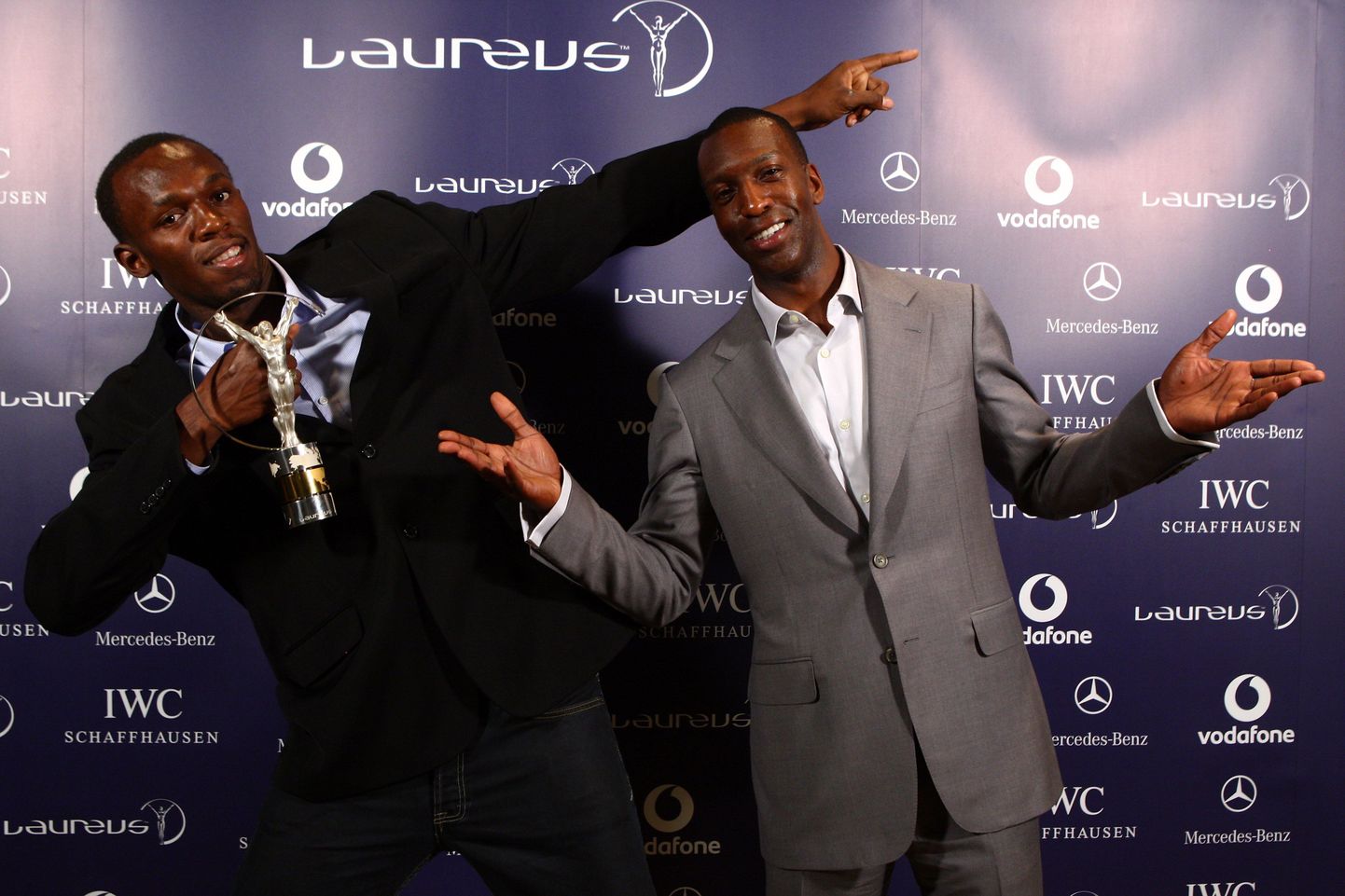 Usain Bolt (vasakul) ja Michael Johnson