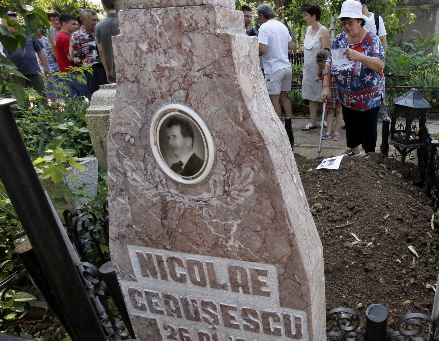 Meedia ja rumeenlased juulis Nicolae Ceausescu haua juures pärast tema surnukeha ekshumeerimist.