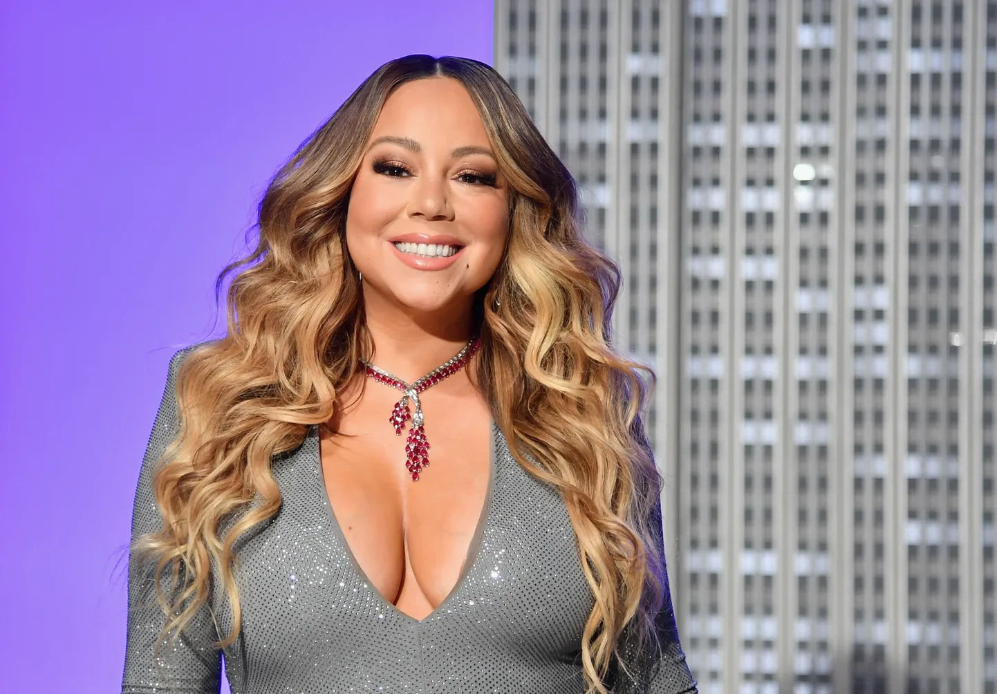 (FILES) In this file photo taken on December 17, 2019 US singer Mariah Carey participates in the ceremonial lighting of the Empire State Building in celebration of the 25th anniversary of "All I Want For Christmas Is You." - Carey has had a long list of hits over the years, but her classic holiday song has helped her make history as the first artist to top the Billboard charts in four separate decades. "All I Want For Christmas Is You" is atop the Billboard Hot 100 for the week dated January 4, 2020, based on sales, radio airplay and streaming data -- its third week atop the rankings. That means Carey has had a number one single in the 1990s, 2000s, 2010s and 2020s. (Photo by Angela Weiss / AFP)