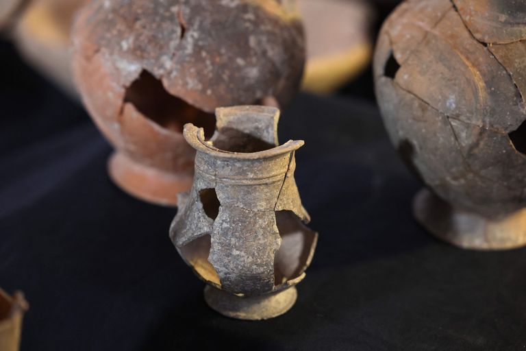 This picture taken on September 20, 2022 shows some of vessels that are believed to have contained opium in the 14th century BC, found at the Tel Yehud burial site, on displayed at the Israel Antiquities Authority offices in Jerusalem. - Israeli experts on September 20 said that they had uncovered the oldest known evidence of opium use, after discovering residue of the hallucinogenic drug in pottery dating from the 14th Century BC. A joint study by the Israel Antiquities Authority and Weizmann Institute of Science found evidence that opium was used in burial rituals in Canaan, a ancient territory that roughly encompasses modern day Israel and the Palestinian territories. (Photo by AHMAD GHARABLI / AFP)