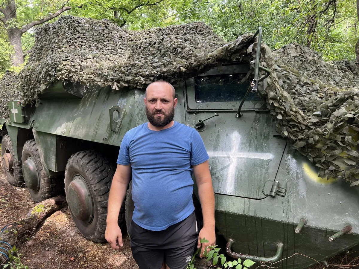 92nd Assault Brigade armored vehicle driver Oleksandr in front of his BTR. He himself is from the Kharkiv region, which he helped liberate two years ago during the counteroffensive. He has fought with the same vehicle for two and a half years.