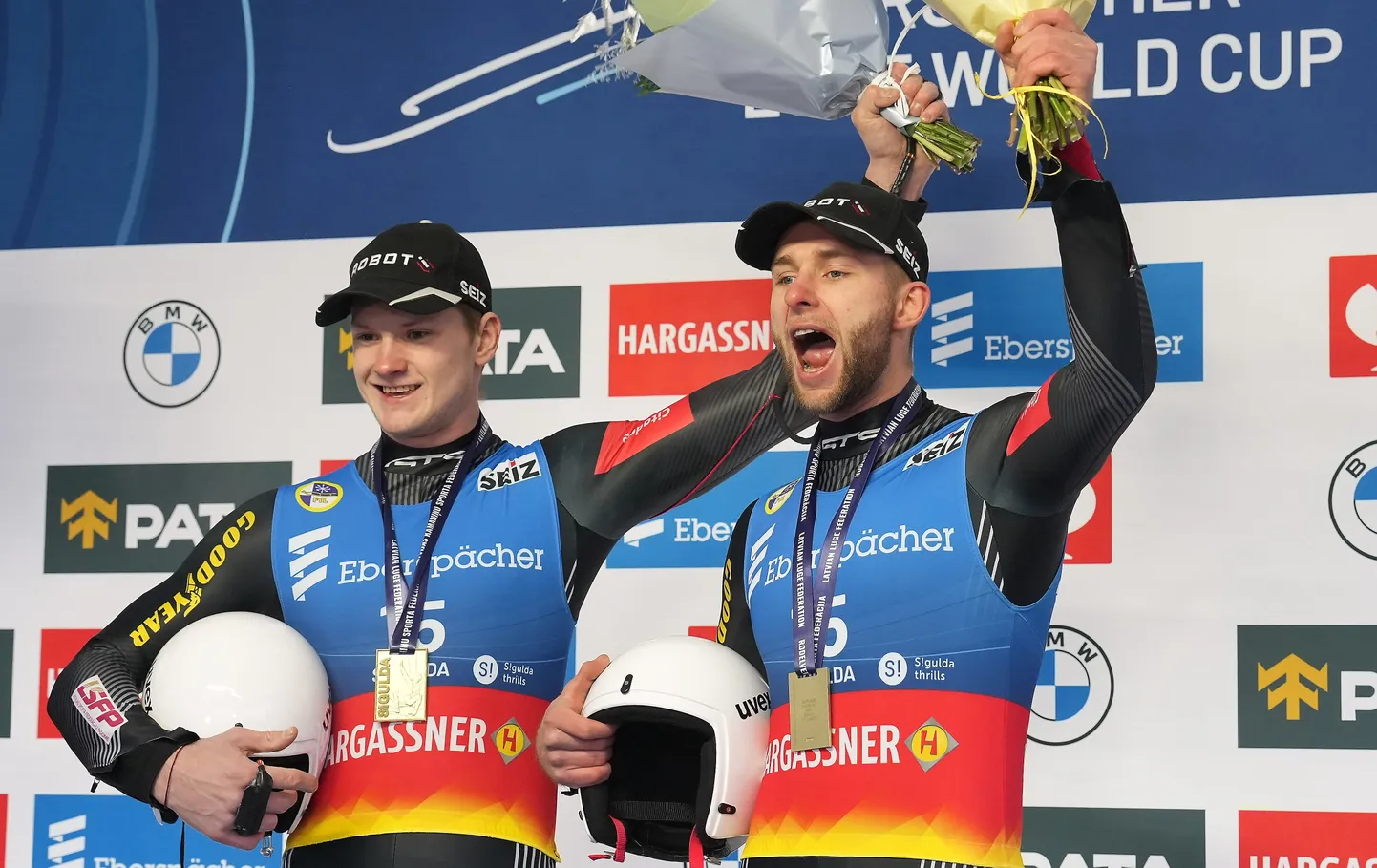 Uzvarētāji Latvijas sportistu divnieks MārtiņšBolts/Roberts Plūme "Eberspracher" Pasaules kausa ceturtajā  posmā kamaniņu sportā apbalvošanas ceremonijā.