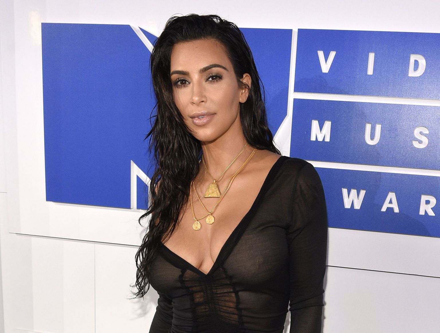 FILE - In this Aug. 28, 2016 file photo, Kim Kardashian West arrives at the MTV Video Music Awards in New York. Kardashian West is suing online media outlet, MediaTakeOut.com, saying she was wrongly portrayed as a liar and thief after she was attacked in Paris. Police say armed robbers forced their way into a private residence where Kardashian West was staying on Oct. 3, tied her up and stole $10 million worth of jewelry. (Photo by Chris Pizzello/Invision/AP, File)