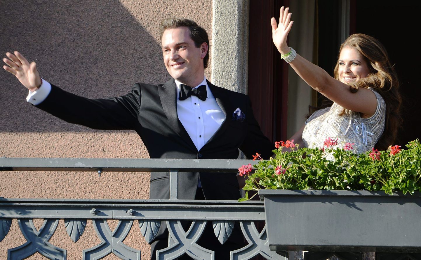 Rootsi printsess Madeleine (paremal) ja tema kihlatu Christopher O'Neill lehvitavad Stockholmi Grand Hoteli rõdult rahvale. Foto on tehtud eile enne pulmapäevale eelnenud suurt pidulikku õhtusööki.