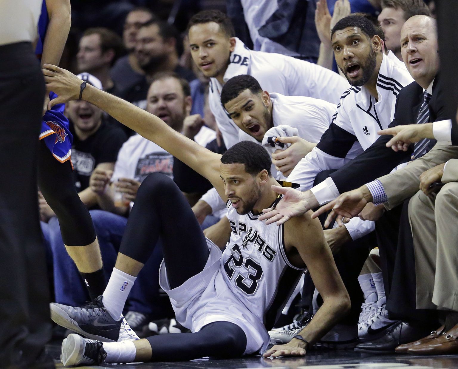 San Antonio Spurs' Austin Daye (23) and the Spurs bench look for a foul call after he crashed to the floor after hitting a basket against the New York Knicks during the first half of an NBA basketball game, Wednesday, Dec. 10, 2014, in San Antonio. (AP Photo/Eric Gay)