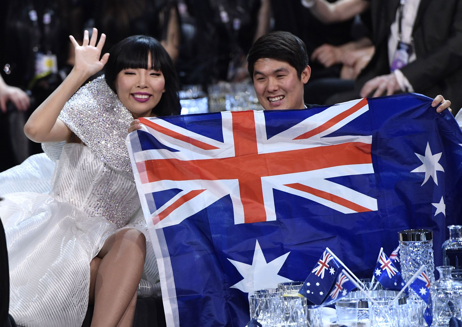 Australia's Dami Im, left, holds an Australian flag during the second Eurovision Song Contest semifinal in Stockholm, Sweden, Thursday, May 12, 2016. (AP Photo/Martin Meissner)