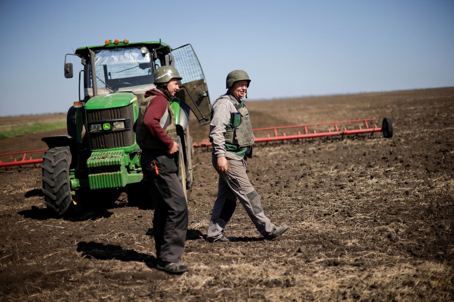 Ukraina põllumehed peavad sõja tõttu kandma põllul töötades kuuliveste ja kaitsekiivreid. Foto on tehtud mai alguse Zaporižžja oblastis