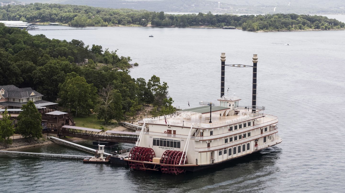 This photo shows a Showboat Branson Belle riverboat docked on Table Rock Lake near Branson, Mo., Friday, July 20, 2018, a day after a duck boat capsized and sank in the lake. Stone County Sheriff Doug Rader said Friday an off-duty deputy aboard a nearby Showboat Branson Belle and others on the riverboat jumped in to help the duck boat's passengers. He described the rescue effort as "outstanding." (Rich Sugg/The Kansas City Star via AP)
