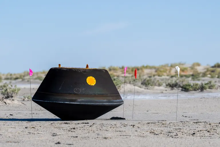 The sample return capsule from NASA’s OSIRIS-REx mission is seen shortly after touching down in the desert, Sunday, Sept. 24, 2023, at the Department of Defense's Utah Test and Training Range. The sample was collected from the asteroid Bennu in October 2020 by NASA’s OSIRIS-REx spacecraft. Photo Credit: (NASA/Keegan Barber)