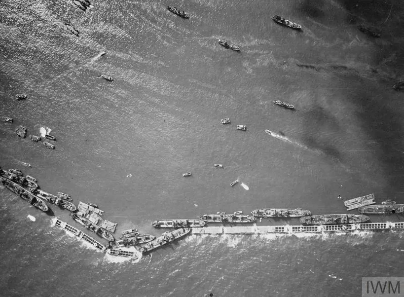 An aerial view of a line of blockships which were introduced into the Mulberry harbours at Arromanches to enlarge the area of sheltered water.