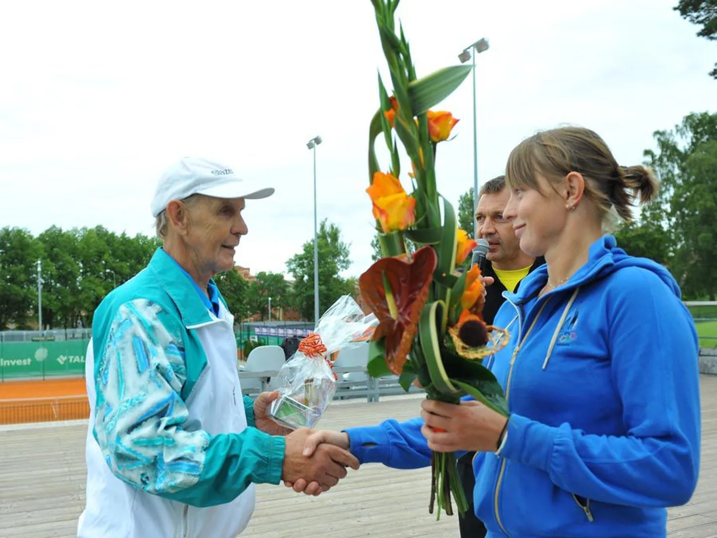 Toomas Leiust õnnitleb äsja karjääri lõpetanud Maret Ani, taustal paistab ka Eesti Tennise Liidu president Urmas Sõõrumaa.