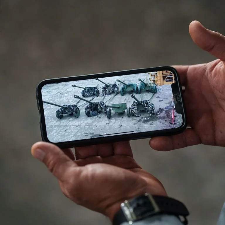 Töötaja näitab telefonist Metinvesti peibutisi.