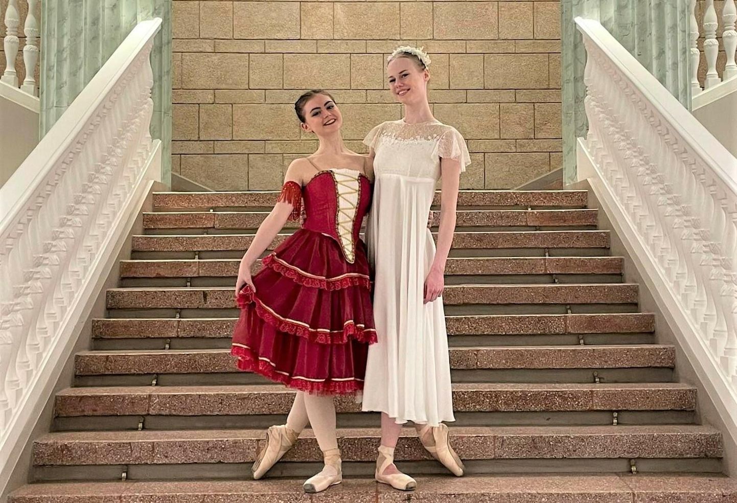 Jette Pruulmann (vasakul) ja Miina Eliise Luts on VEFi kultuuripalee trepil Riias kostüümides, millega nad tantsisid ka laval.