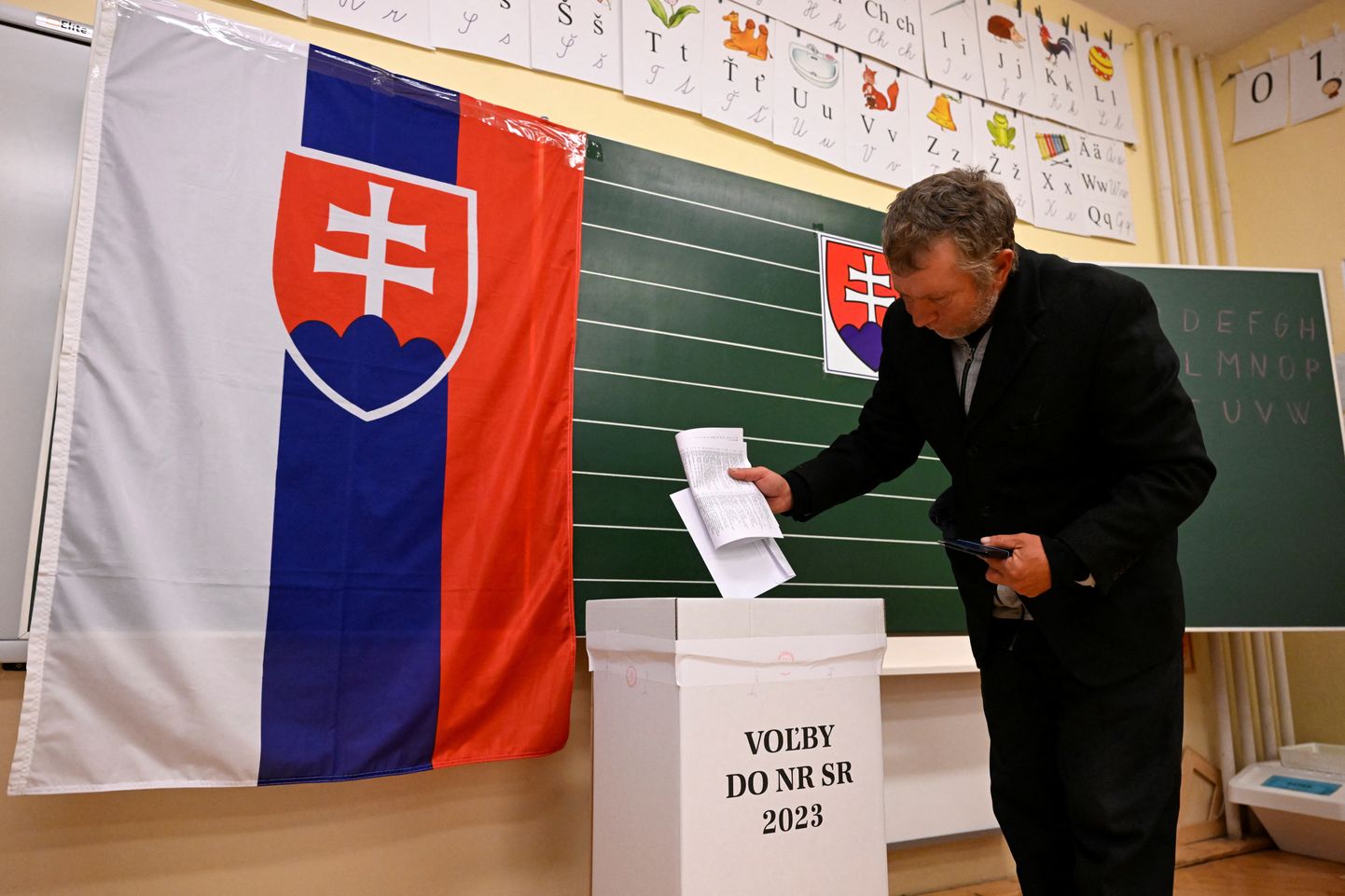 A person casts a ballot at a polling station during the country's early parliamentary election in Trencianske Stankovce, Slovakia, September 30, 2023. REUTERS/Radovan Stoklasa