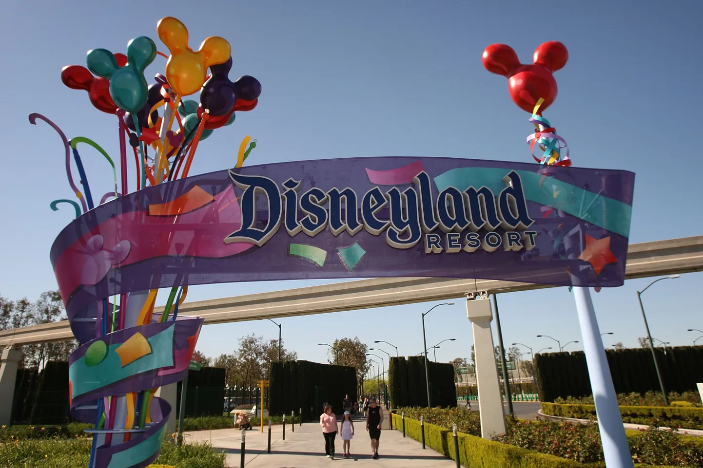 LOS ANGELES, CA - FEBRUARY 19: Pedestrians walk near the entrance to Disneyland Resort on February 19, 2009 in Anaheim, California. With the worsening economy, declining attendance and reduced operating income, the Walt Disney Company announced that it plans to restructure its domestic theme-park operations, which will result in the layoff an unspecified number of employees in the coming weeks. Disneyland in Anaheim, California and Walt Disney World in Orlando, Florida will reportedly be consolidated into a single unit headed by Worldwide Operations President Al Weiss. Attendance at Disney theme parks in the US dropped 5 percent in the last quarter of 2008 compared to the previous year and in January, Disney offered buyout packages to 600 US executives.   David McNew/Getty Images/AFP