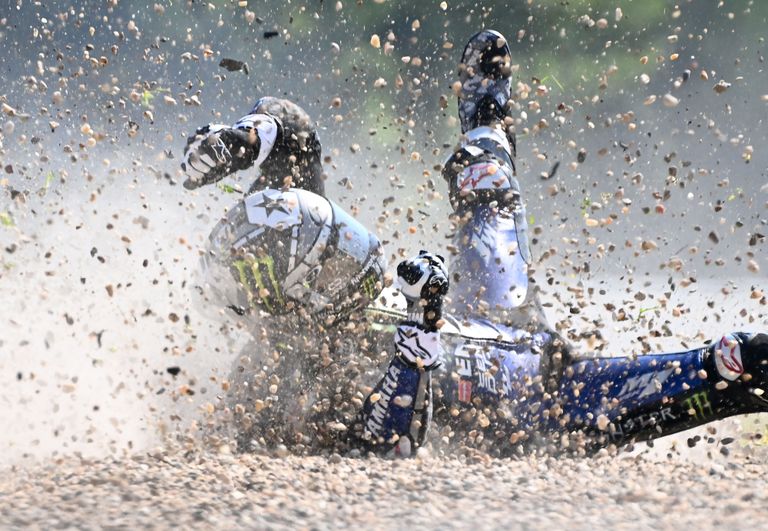 Monster Energy Yamaha's Spanish rider Maverick Vinales rolls on the ground after he crashed during the first training session ahead of the Moto GP Czech Grand Prix at Masaryk's circuit in Brno on August 7, 2020. (Photo by JOE KLAMAR / AFP)